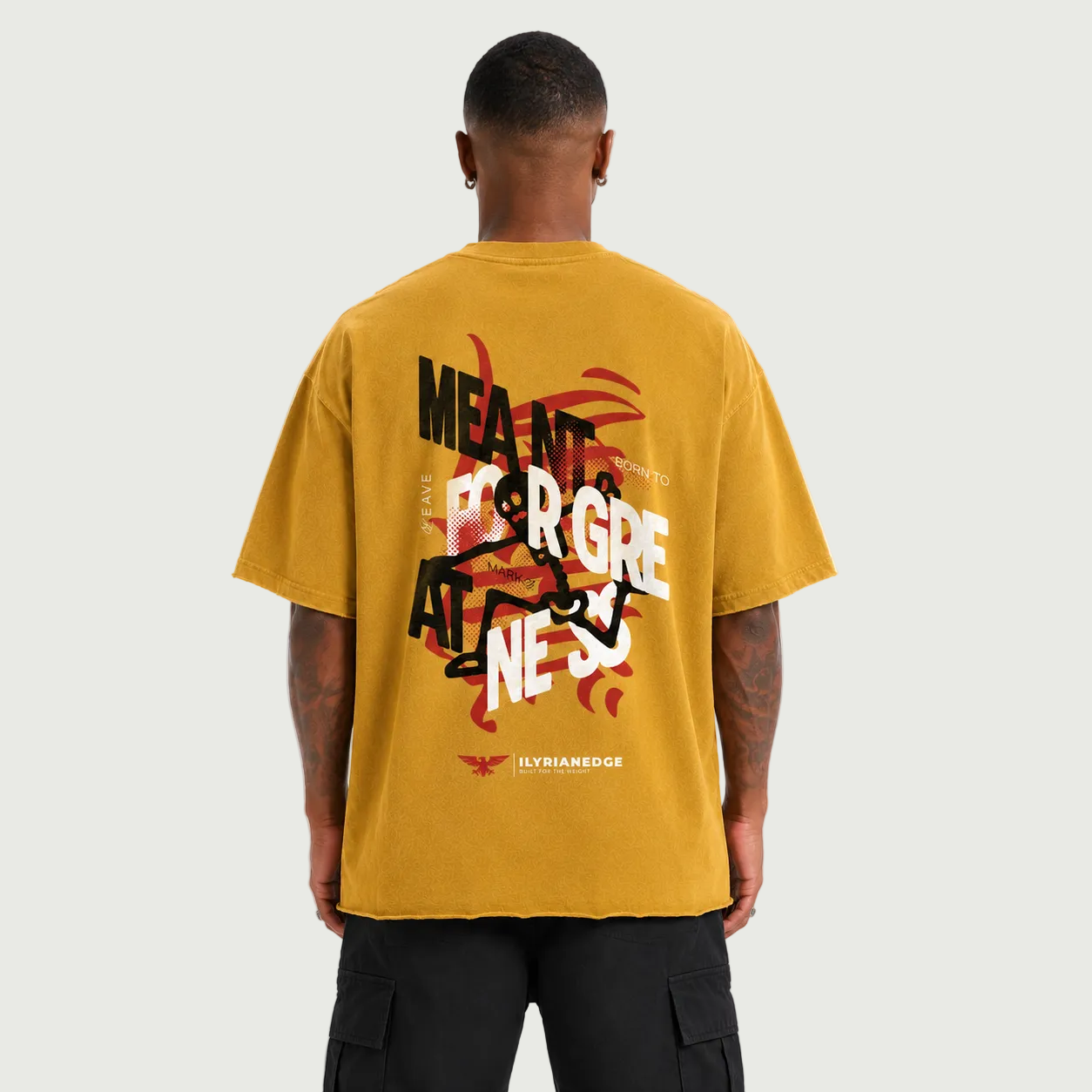 Person wearing a mustard yellow t-shirt with graphic design and text on the back, on a white background.