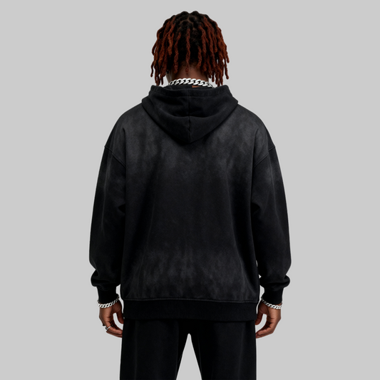 Person wearing a black hoodie with a white chain necklace on a white background