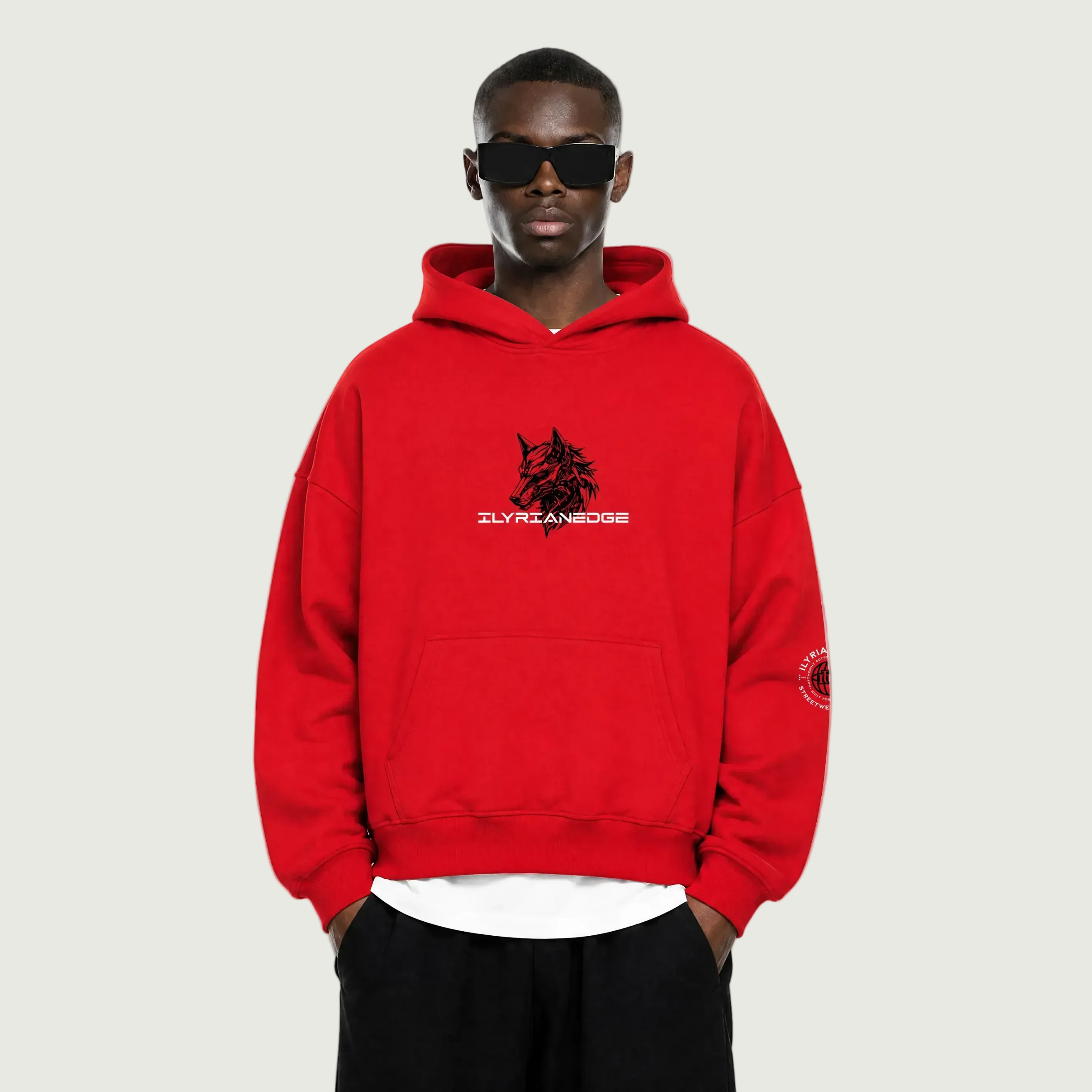 Person wearing a red hoodie with a logo on a white background