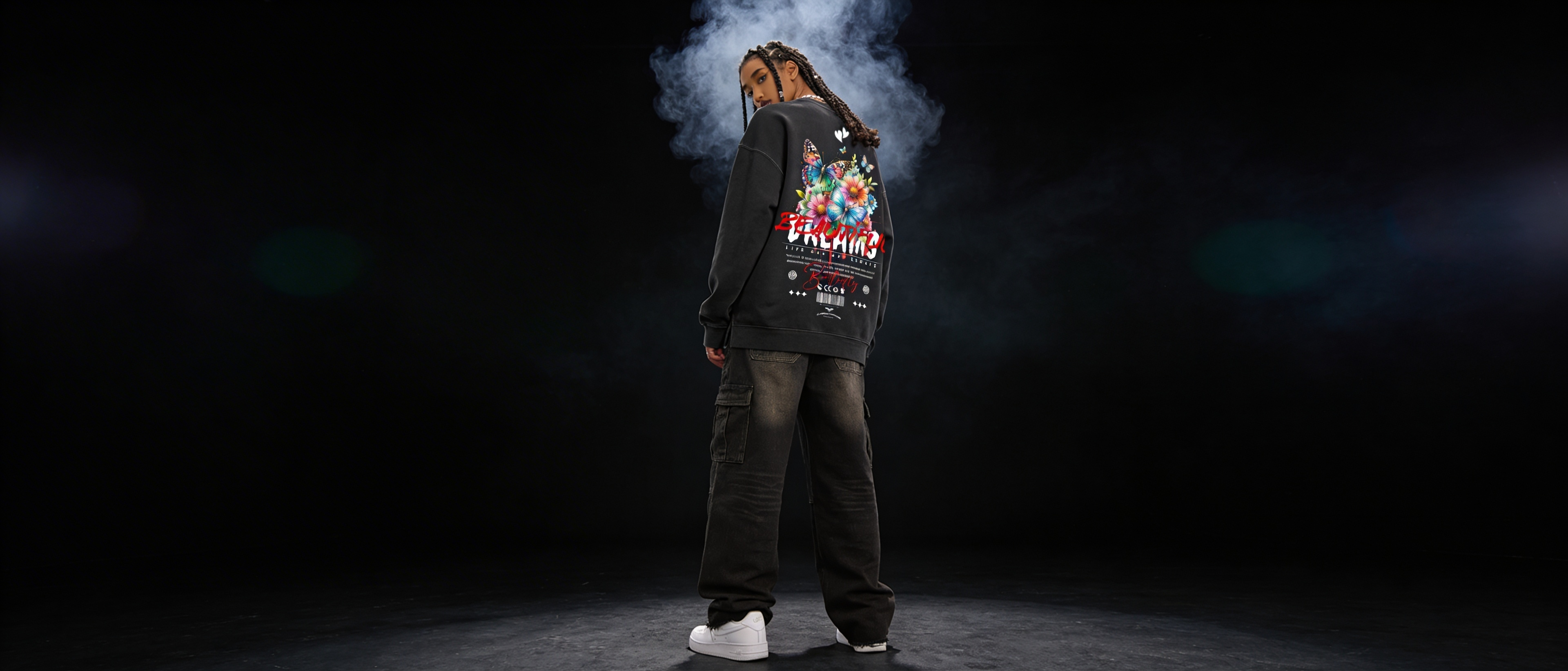 Person wearing a jacket with a colorful design on the back against a dark background
