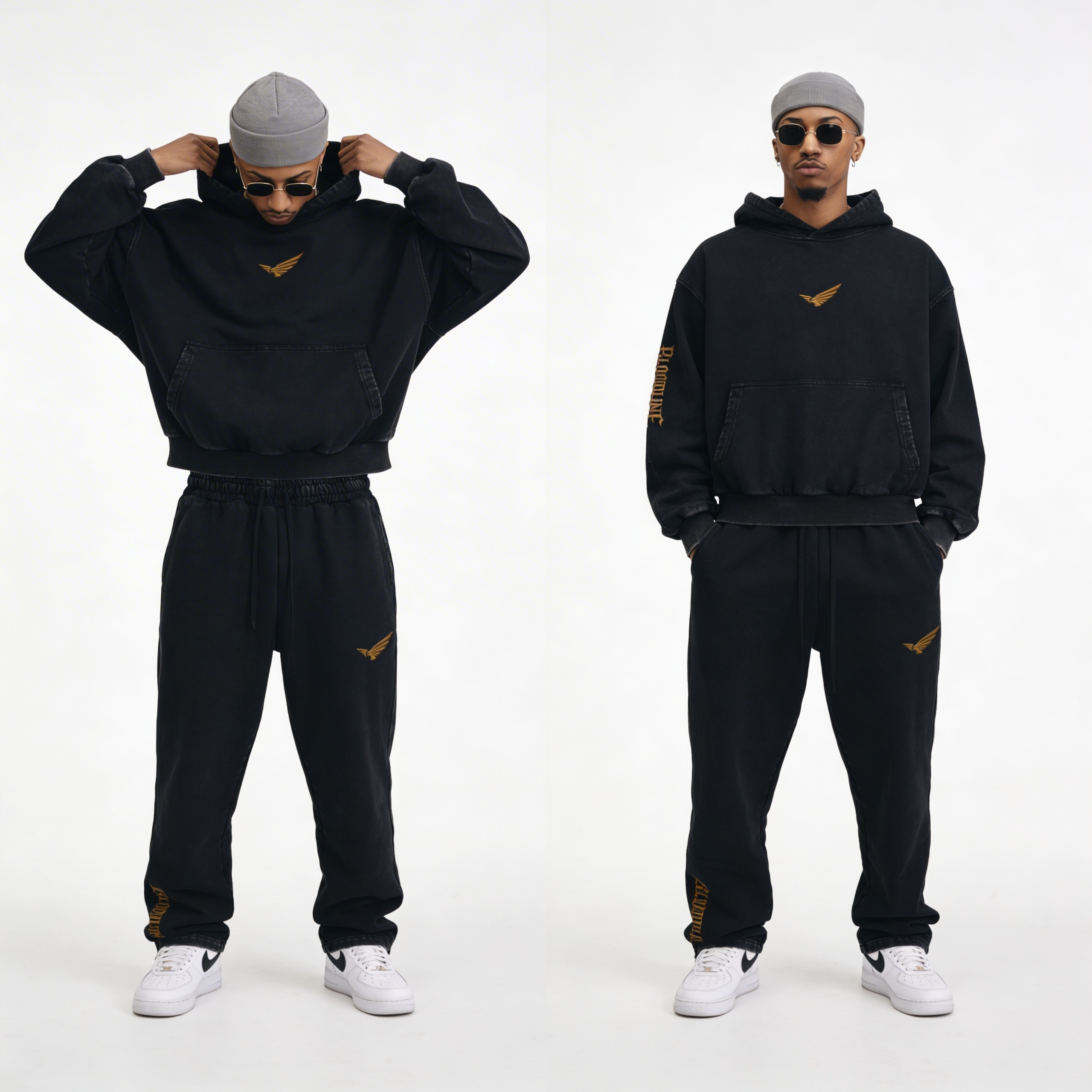 Two people wearing black tracksuits with gold logos on a white background