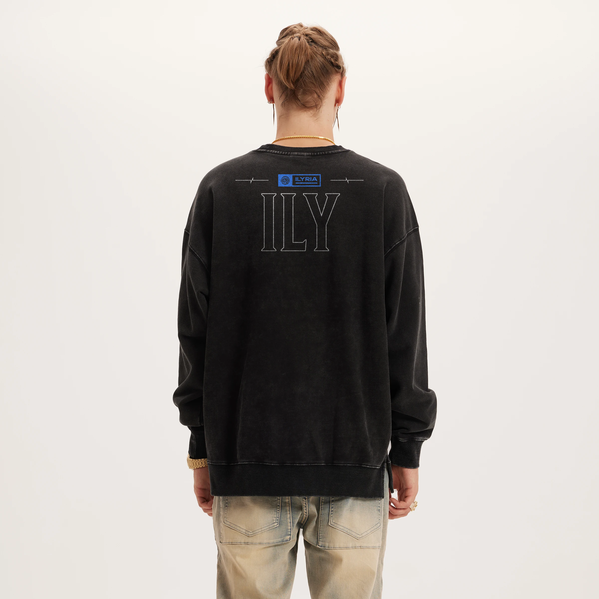 Person wearing a black sweatshirt with 'ILY' printed on the back against a white background
