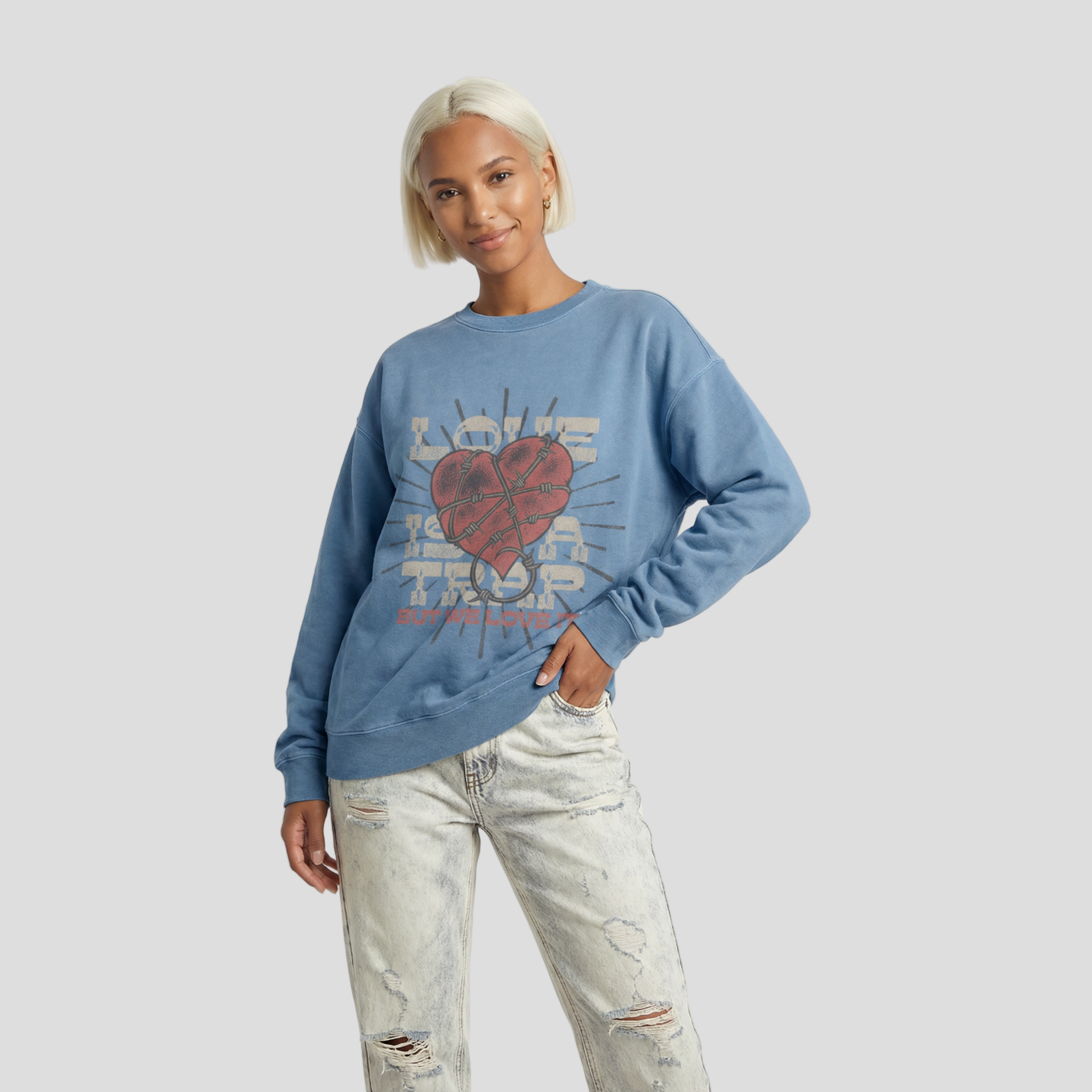 Woman wearing a blue sweatshirt with a heart design on a white background