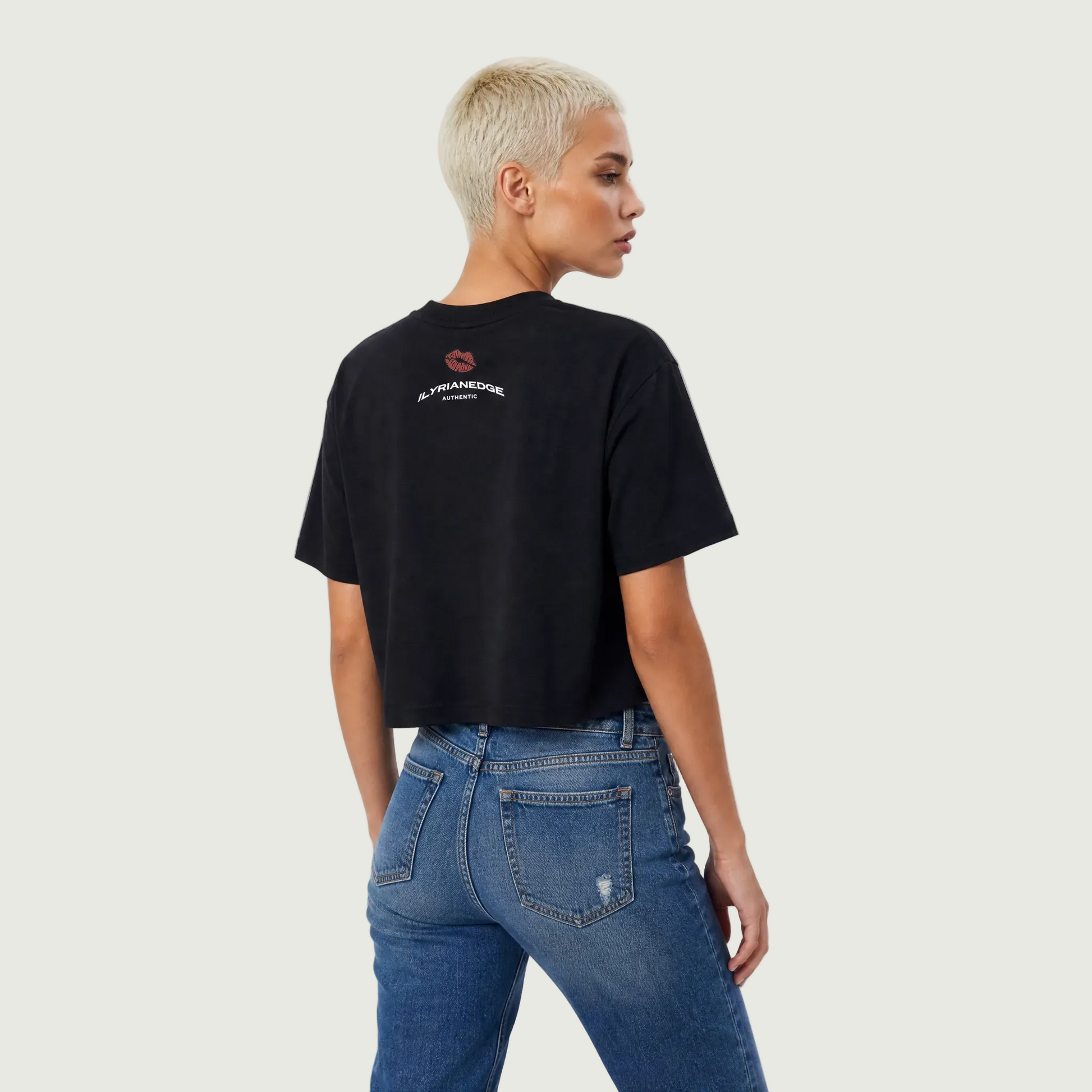 Person wearing a black t-shirt with text and blue jeans on a white background