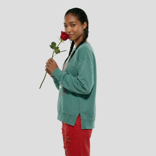 Woman holding a red rose against a white background