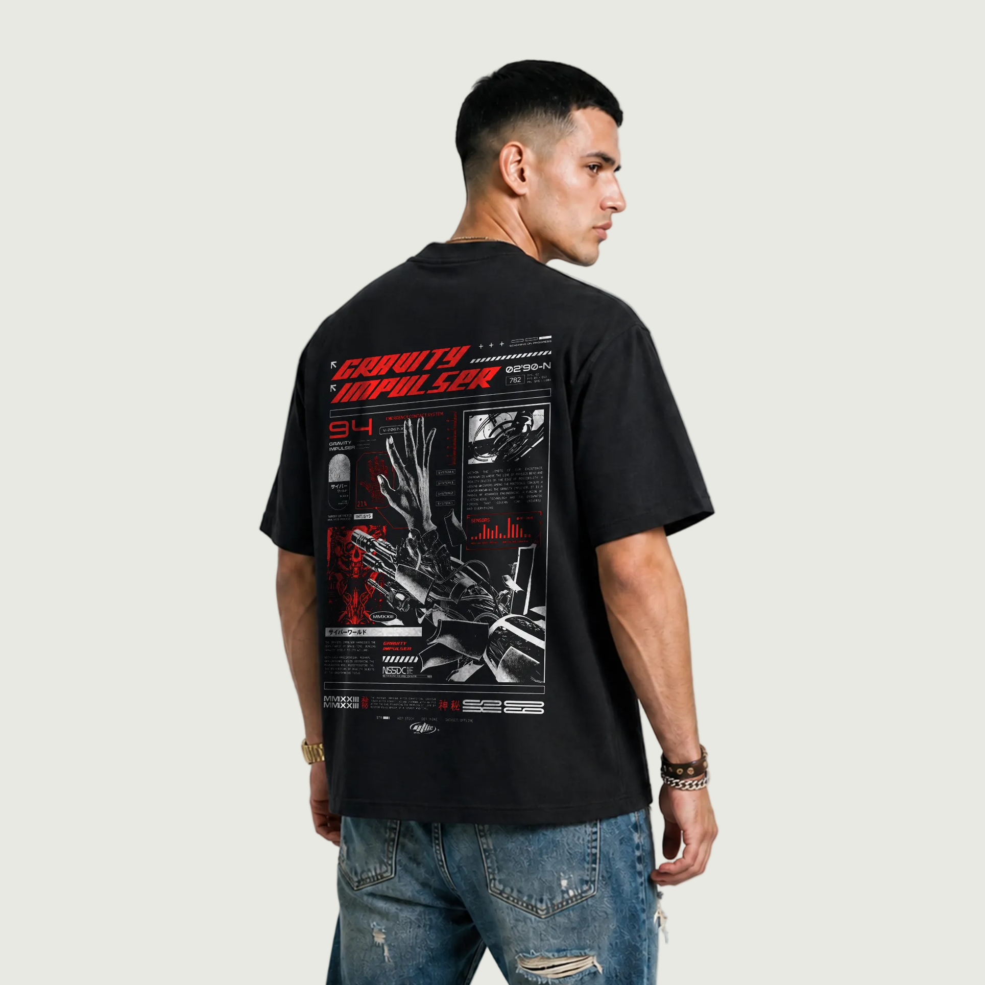 Man wearing a black t-shirt with graphic design on the back against a plain background