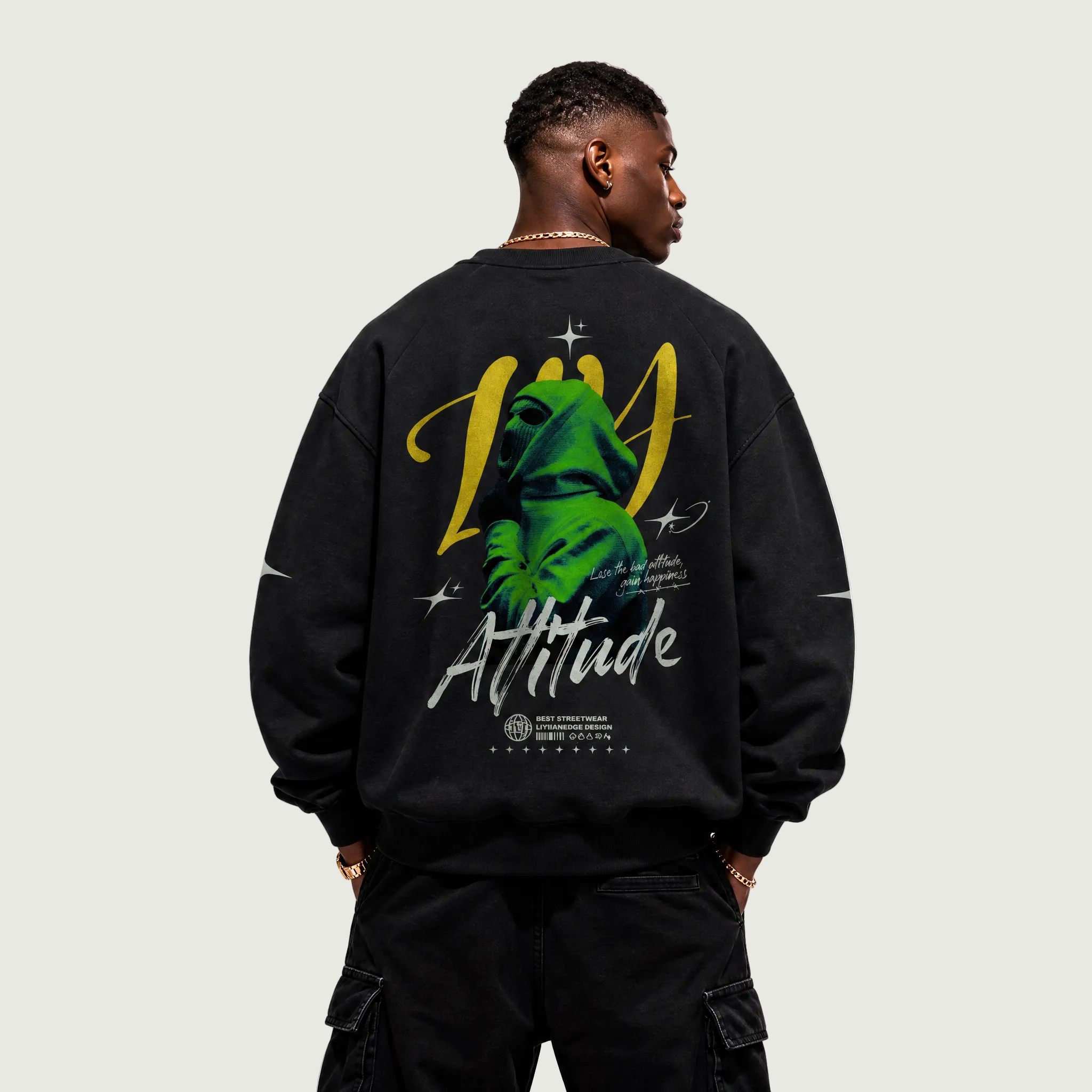Person wearing a black sweatshirt with a colorful graphic on the back against a white background