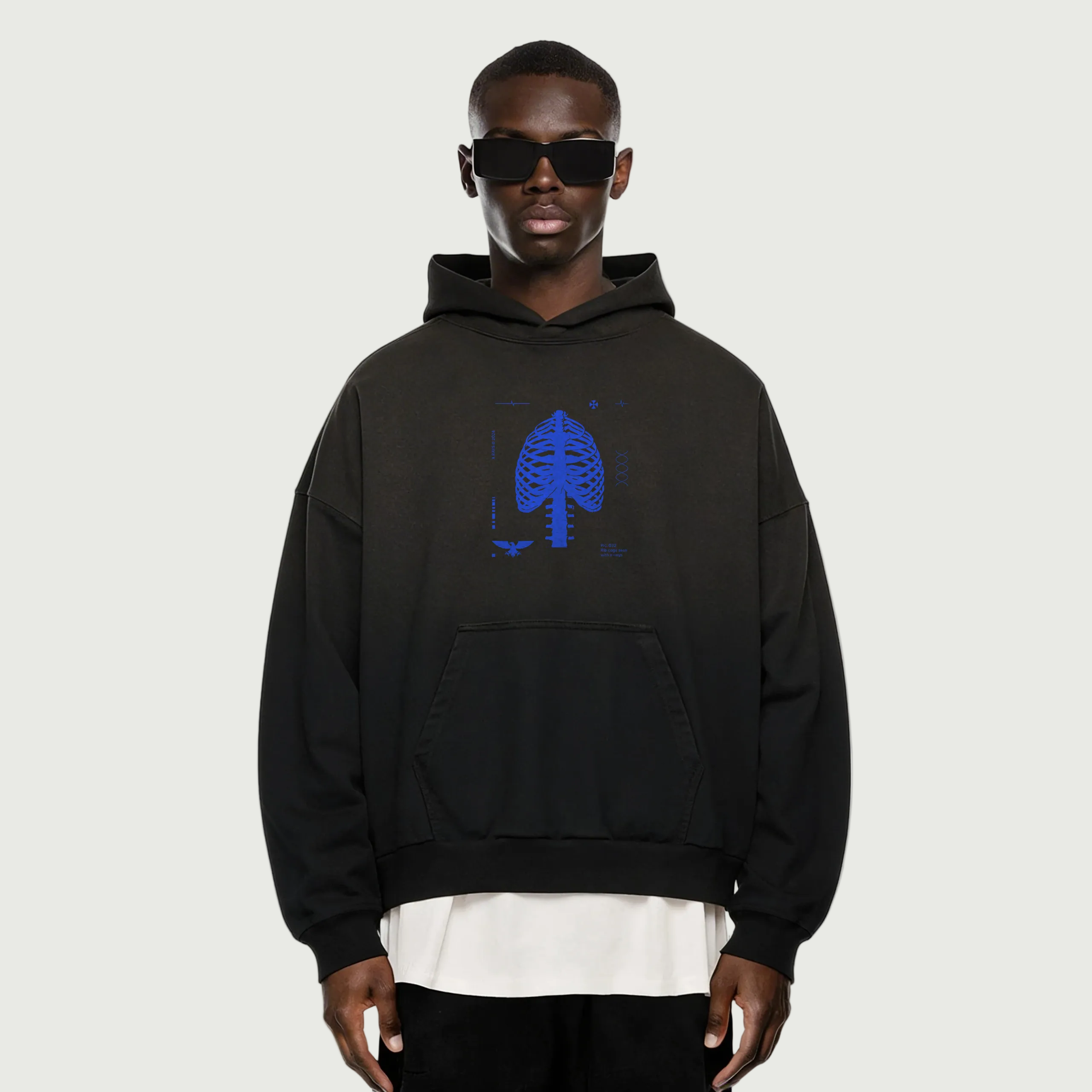 Person wearing a black hoodie with a blue logo on a white background