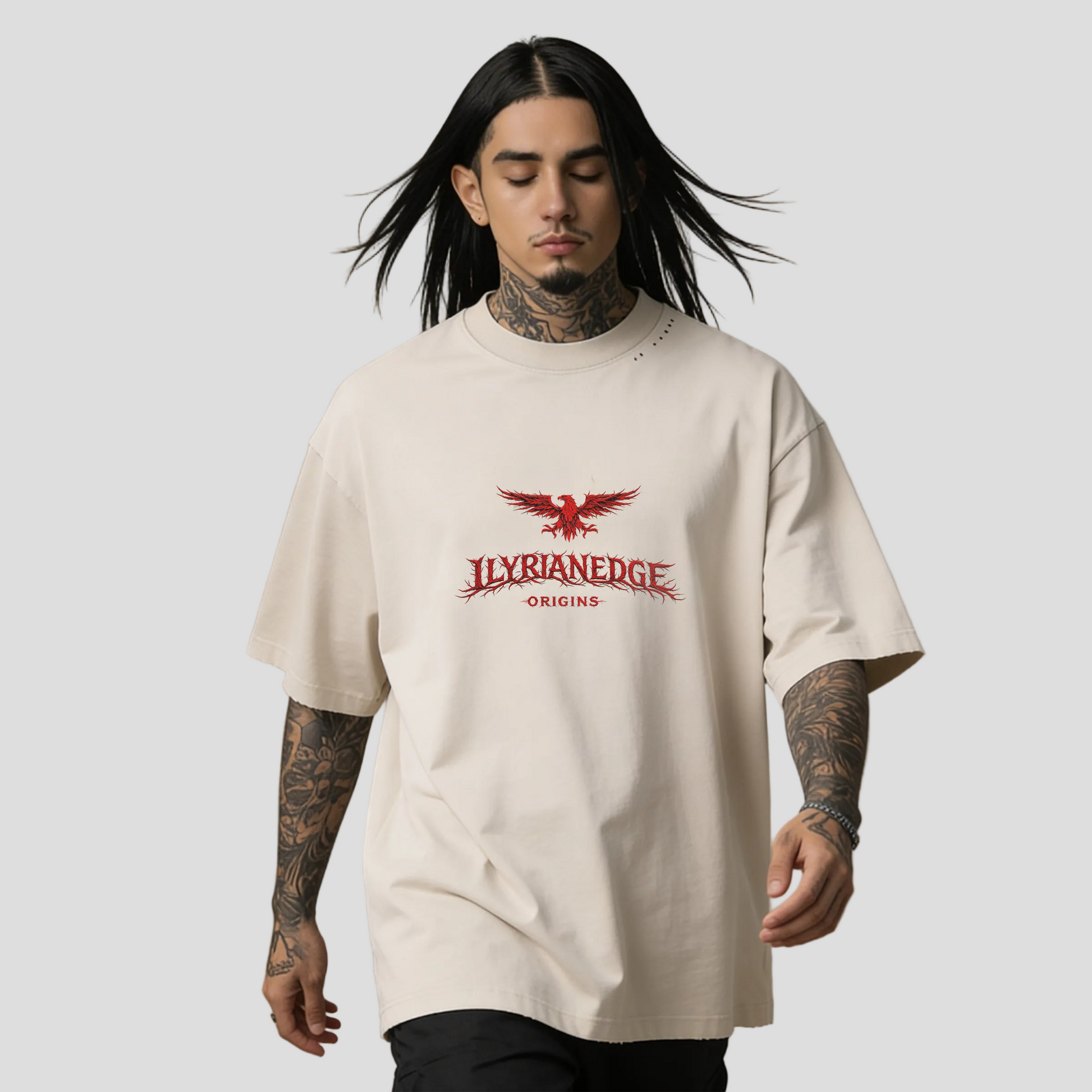 Person wearing a beige t-shirt with a red logo on a brown background